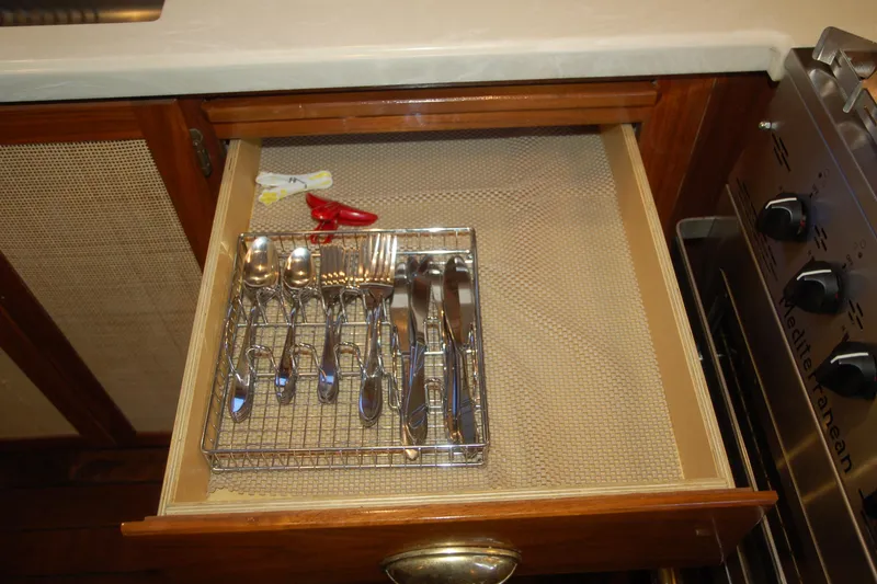 Slide: The Image of Open kitchen drawer with cutlery organizer, featuring spoons, forks, and knives. Custom Sprague 2006 model. - 121