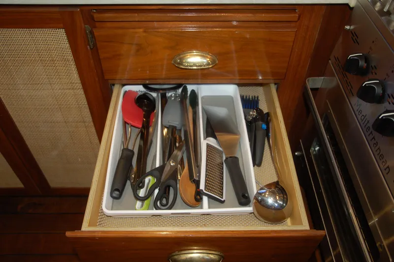 Slide: The Image of Kitchen drawer with assorted utensils in a 2006 Custom Sprague model. - 123