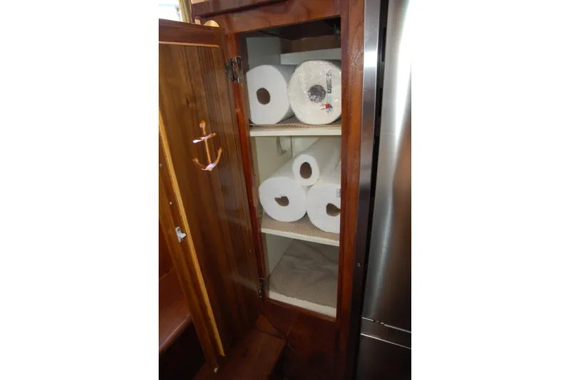 Slide: The Image of Wooden cabinet with shelves storing paper towels, Custom Sprague 2006 model. - 131