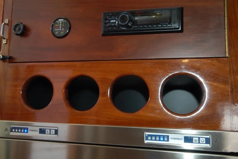 Slide: The Image of Wooden panel with circular cutouts, stereo system, and Vitrifrigo controls, Custom Sprague 2006. - 132