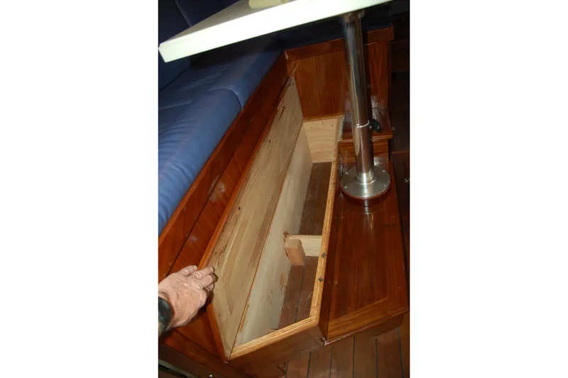 Slide: The Image of Wooden storage compartment under seating in a 2006 Custom Sprague boat interior. - 133