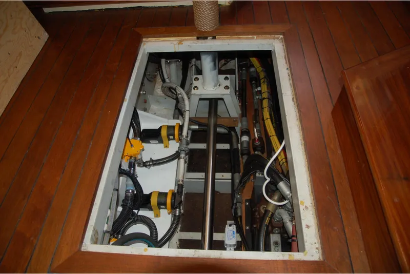 Slide: The Image of Engine compartment of a 2006 Custom Sprague boat with visible pipes and cables. - 137