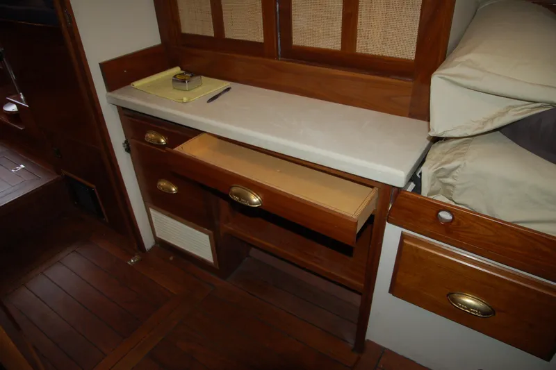 Slide: The Image of Wooden interior with open drawer, beige countertop, and bedding in a 2006 Custom Sprague model. - 143