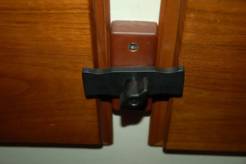 Slide: The Image of Custom Sprague 2006 cabinet latch on wooden doors. - 144