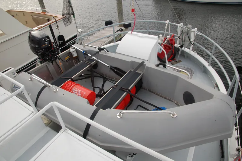 Slide: The Image of Custom 2006 Sprague boat with Tohatsu motor and safety equipment docked at marina. - 157