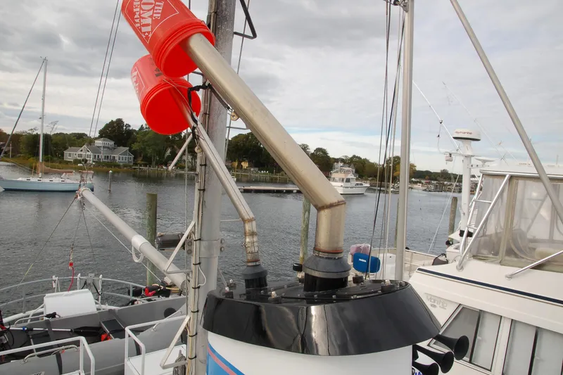Slide: The Image of Custom 2006 Sprague boat with red buckets on deck, docked in a marina. - 158