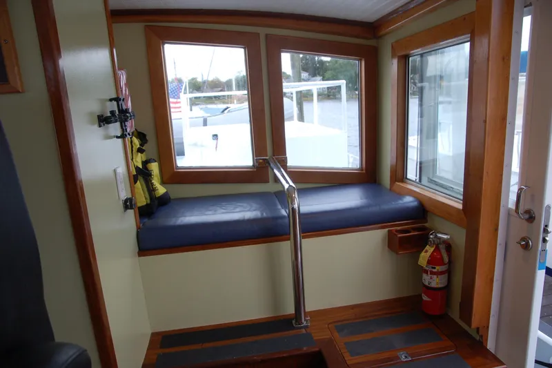 Slide: The Image of Interior of 2006 Custom Sprague boat with seating, windows, and safety equipment. - 16