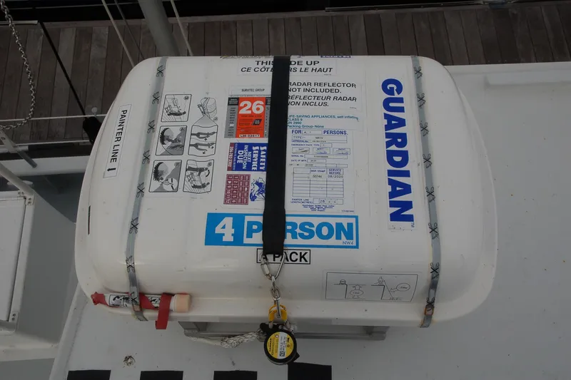 Slide: The Image of Life raft container labeled "Guardian," for 4 persons, secured on a boat deck. - 161