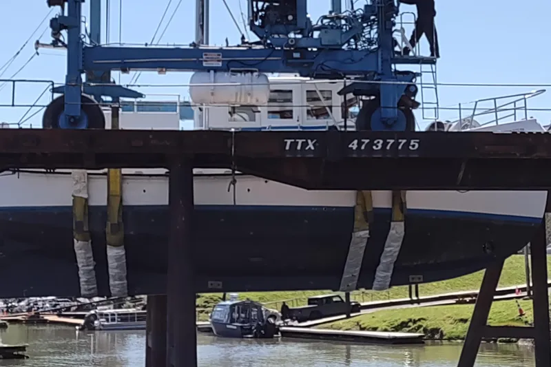 Slide: The Image of Boat lift hoisting Custom Sprague 2006 vessel at dockside. - 179