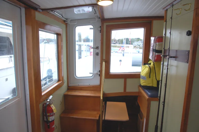 Slide: The Image of Interior of a 2006 Custom Sprague boat with wooden accents and safety equipment. - 18