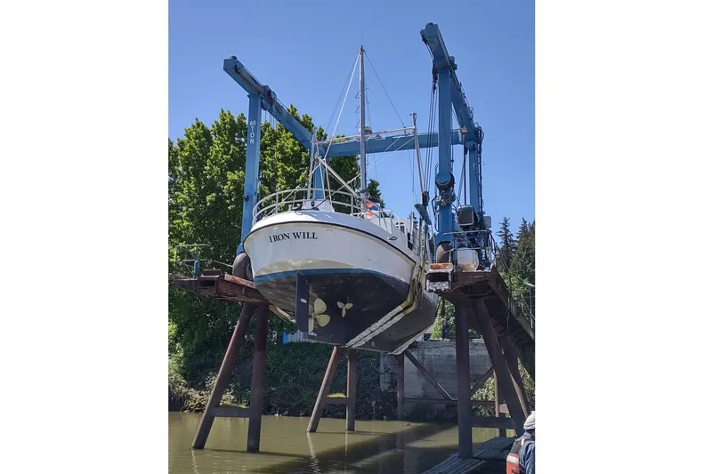 Slide: The Image of Custom 2006 Sprague boat "Iron Will" lifted by crane at dockside. - 180