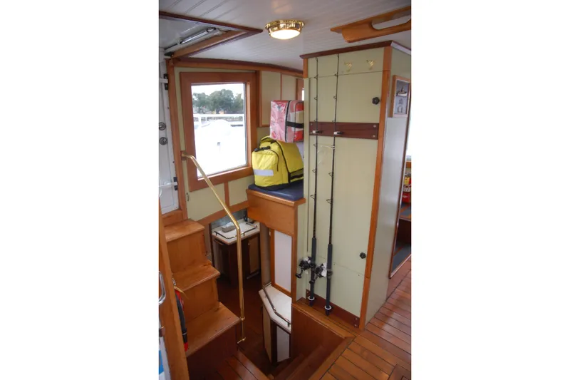 Slide: The Image of Interior of 2006 Custom Sprague boat with fishing rods and storage area. - 21