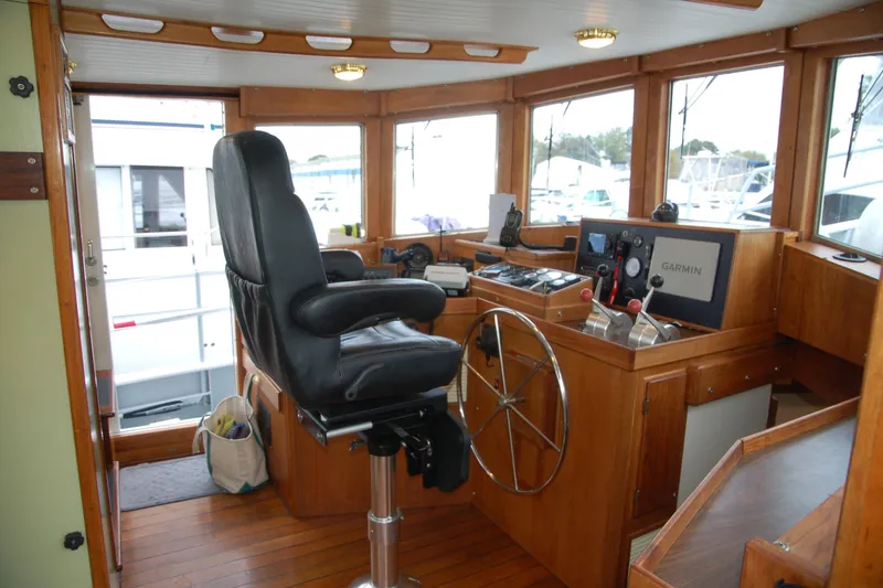 Slide: The Image of Boat helm with leather chair, wooden interior, and Garmin navigation system, Custom Sprague 2006. - 22
