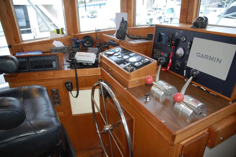 Slide: The Image of Boat cockpit with Garmin navigation, control levers, and steering wheel, Custom Sprague 2006 model. - 23