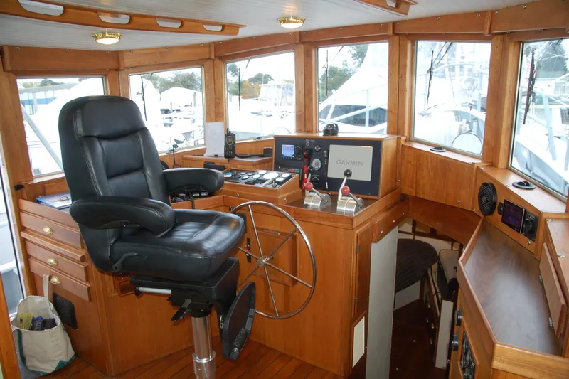 Slide: The Image of Boat helm with leather chair, wooden interior, and navigation equipment, Custom Sprague 2006 model. - 24