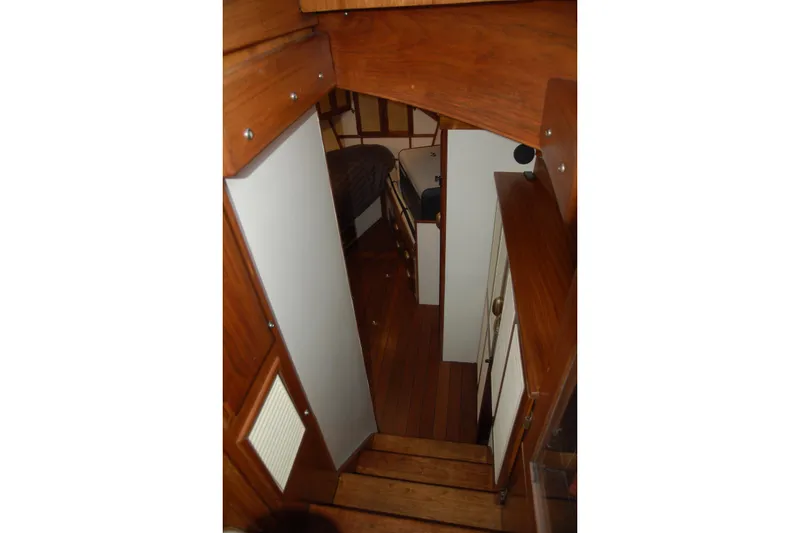 Slide: The Image of Interior view of a 2006 Custom Sprague boat with wooden finishes and cozy cabin space. - 26