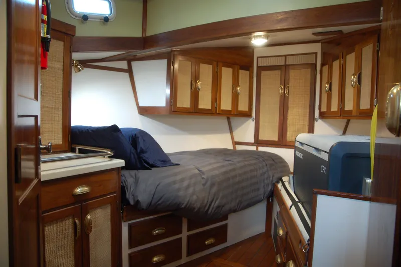 Slide: The Image of Cozy 2006 Custom Sprague boat cabin with wooden cabinets and a comfortable bed. - 28