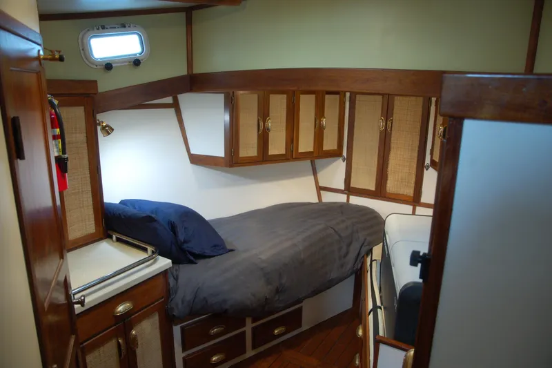 Slide: The Image of Cozy 2006 Custom Sprague boat cabin with wooden cabinets and single bed. - 29
