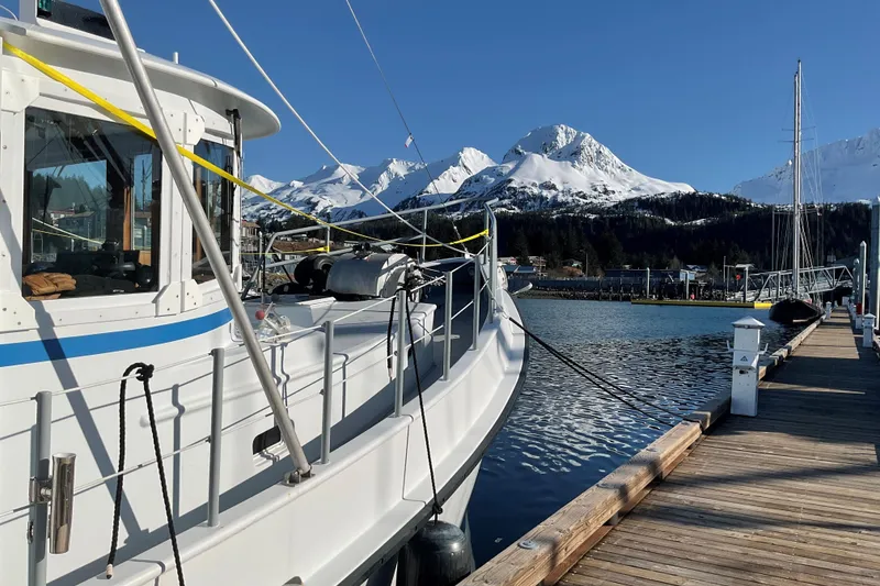 Slide: The Image of Custom 2006 Sprague boat docked with snowy mountains in the background. - 3