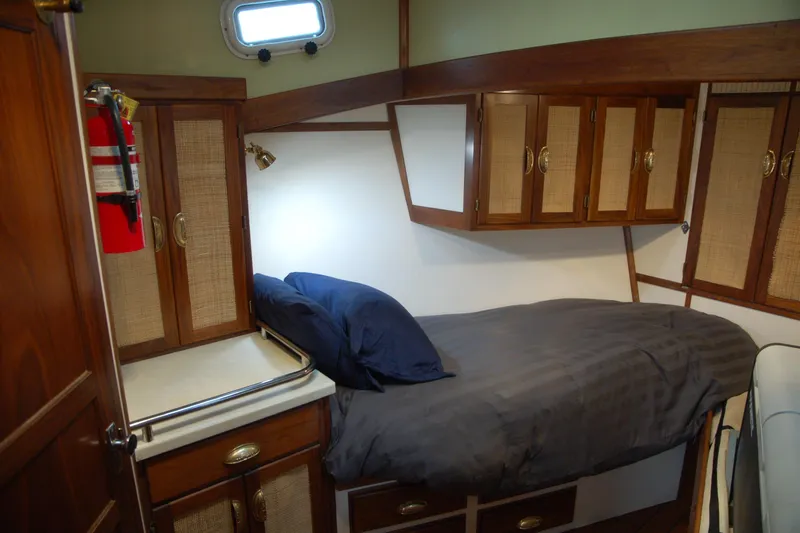Slide: The Image of Cozy 2006 Custom Sprague boat cabin with wooden cabinets and single bed. - 30