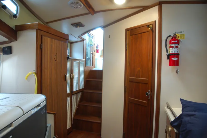 Slide: The Image of Interior of a 2006 Custom Sprague boat with wooden doors and a fire extinguisher. - 31