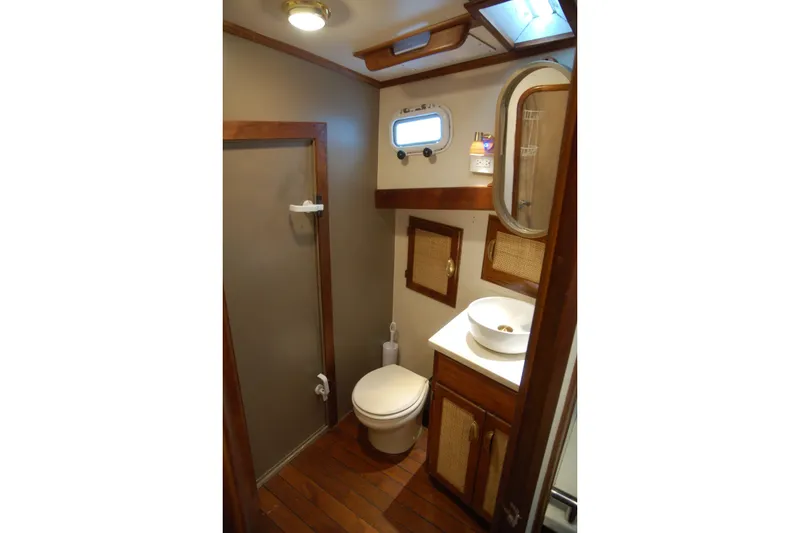 Slide: The Image of Compact 2006 Custom Sprague bathroom with wood accents, shower, and porthole window. - 36