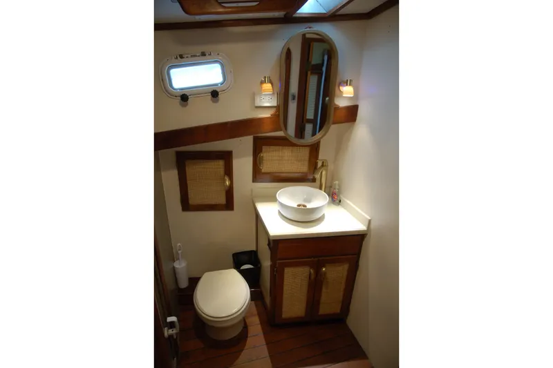Slide: The Image of Compact 2006 Custom Sprague bathroom with wooden accents, oval mirror, and porthole window. - 37