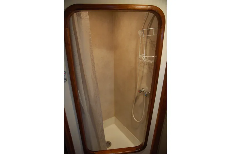 Slide: The Image of Compact shower with wooden frame and curtain in a 2006 Custom Sprague model. - 38