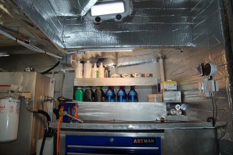 Slide: The Image of Insulated engine room with various maintenance supplies, featuring a Custom Sprague model from 2006. - 42