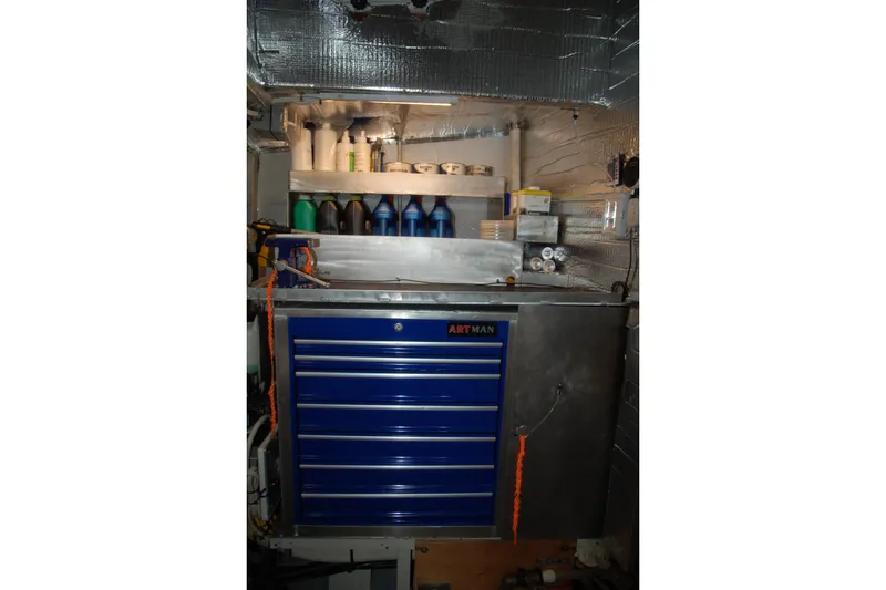 Slide: The Image of Tool storage cabinet with shelves, various bottles, and supplies in a workshop setting, Custom Sprague 2006. - 43