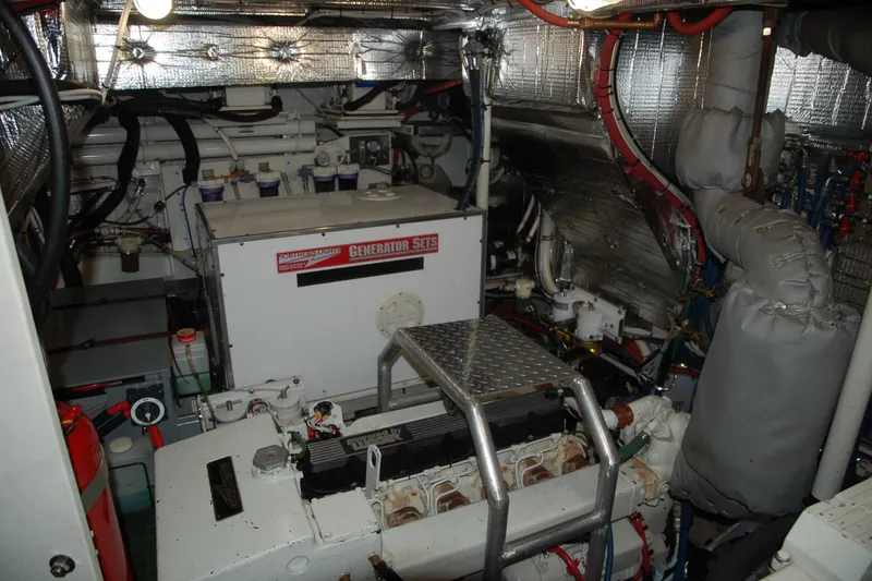 Slide: The Image of Engine room of a 2006 Custom Sprague with generator set and insulated pipes. - 44