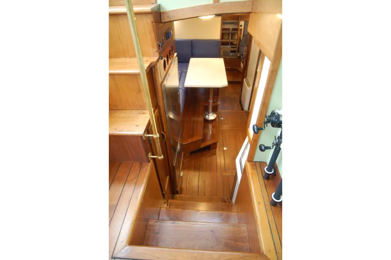 Slide: The Image of Interior of 2006 Custom Sprague boat with wooden stairs and dining area. - 47