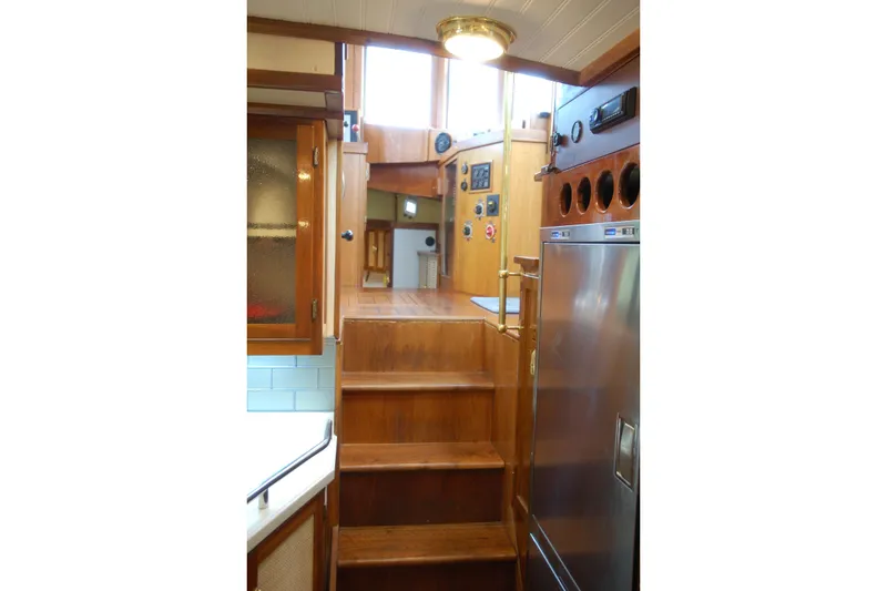 Slide: The Image of Interior of 2006 Custom Sprague boat with wooden stairs and stainless steel appliances. - 48