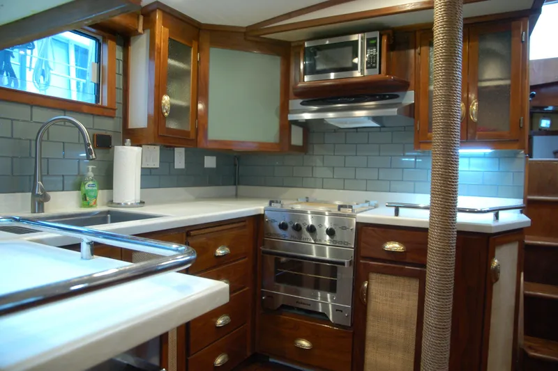 Slide: The Image of Luxurious 2006 Custom Sprague kitchen with wood cabinetry, modern appliances, and sleek countertops. - 53