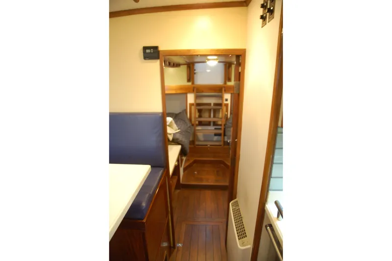 Slide: The Image of Interior of a 2006 Custom Sprague boat with wooden flooring and cozy seating. - 54