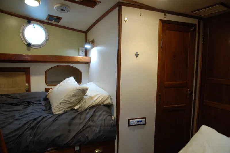 Slide: The Image of Cozy 2006 Custom Sprague boat cabin with bed, porthole, and wooden door. - 55