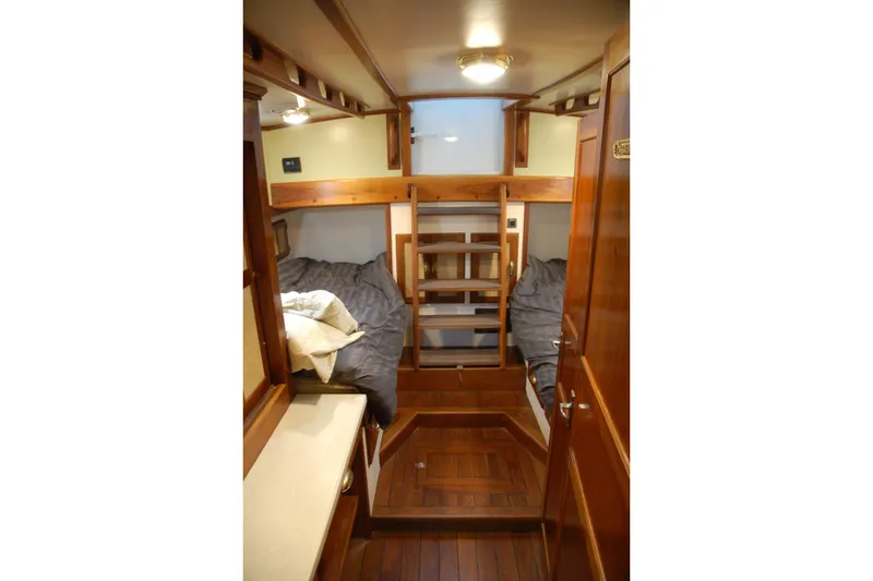 Slide: The Image of Cozy 2006 Custom Sprague cabin interior with wooden finishes and twin beds. - 56