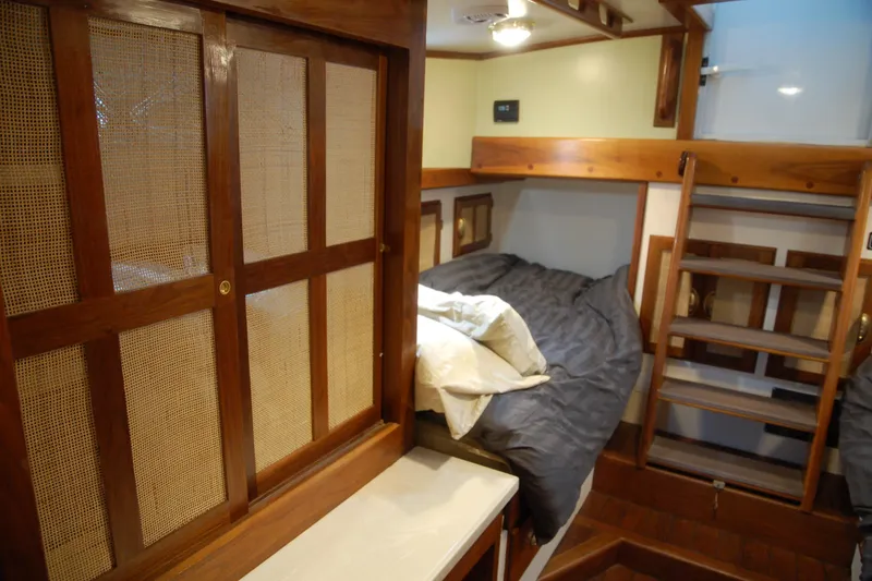 Slide: The Image of Cozy wooden interior of a 2006 Custom Sprague boat cabin with bed and ladder. - 57