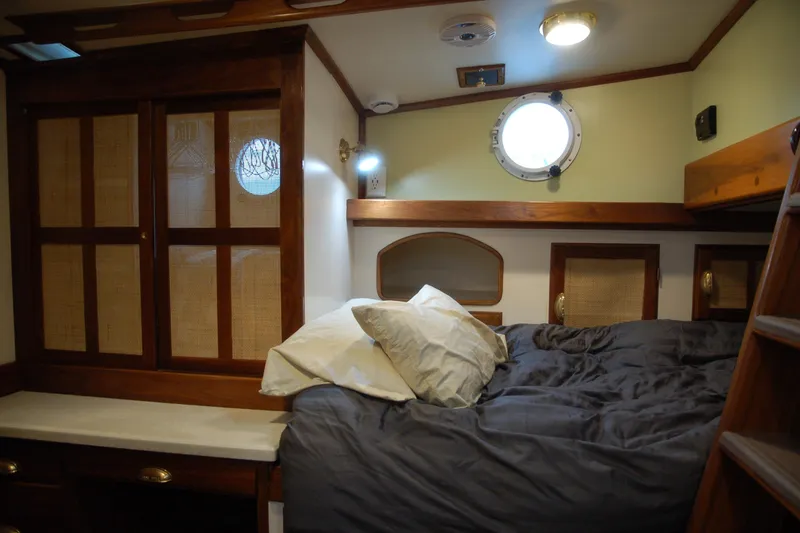 Slide: The Image of Cozy 2006 Custom Sprague cabin interior with bed, wooden accents, and porthole window. - 59