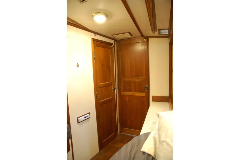 Slide: The Image of Wood-paneled interior of a 2006 Custom Sprague, featuring doors and ceiling light. - 61
