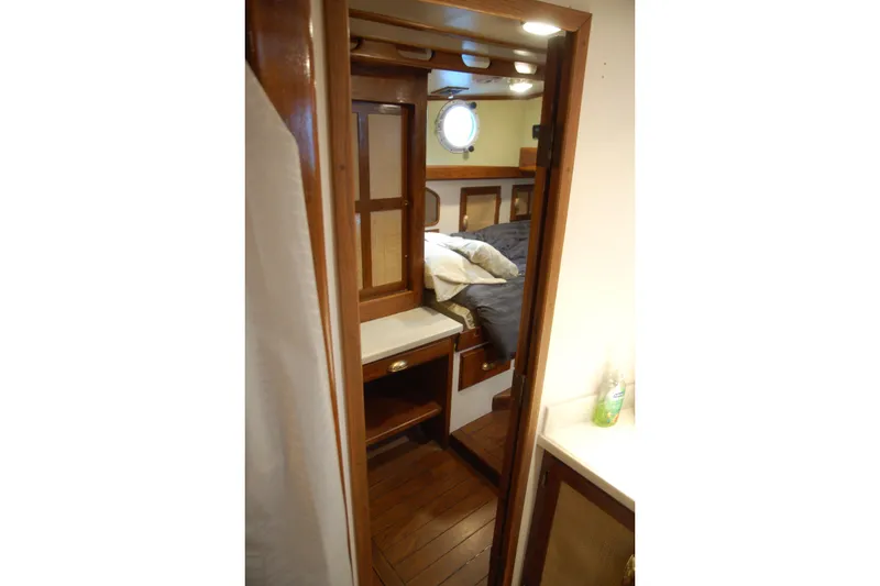 Slide: The Image of Cozy cabin interior of 2006 Custom Sprague boat with wooden furnishings and porthole window. - 65