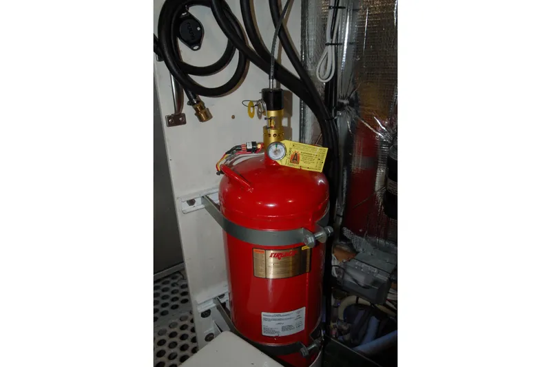 Slide: The Image of Red 2006 Custom Sprague fire extinguisher in an industrial setting with attached hoses. - 71