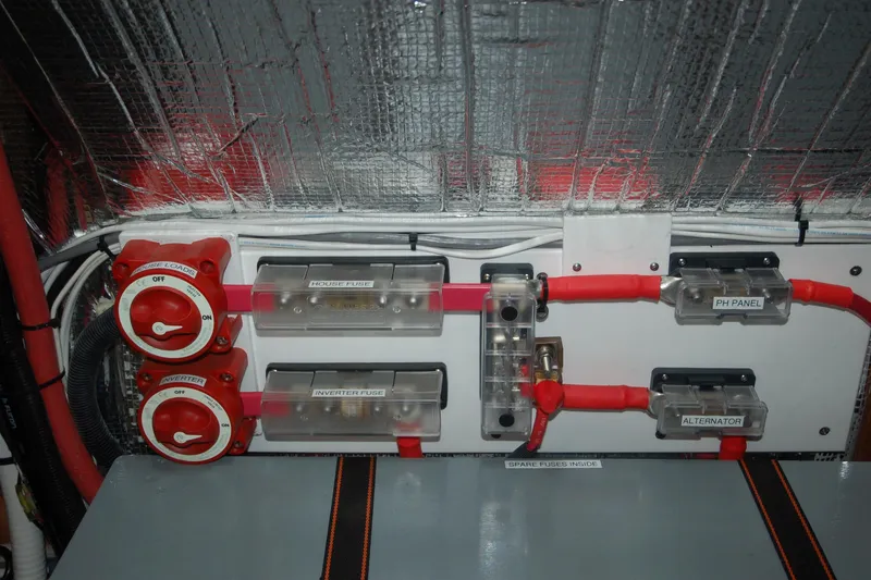 Slide: The Image of Electrical panel with fuses and switches in a 2006 Custom Sprague model. - 72