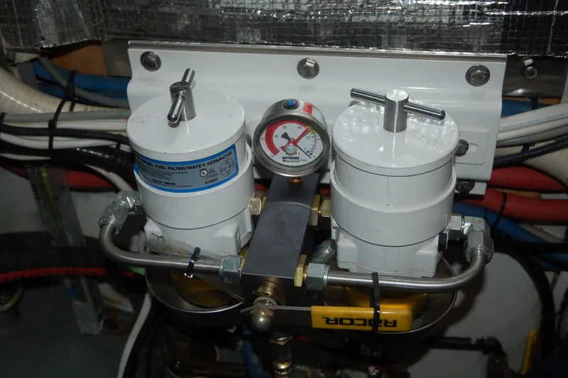 Slide: The Image of Dual fuel filter system with pressure gauge, Custom Sprague 2006 model, in an engine room setup. - 76