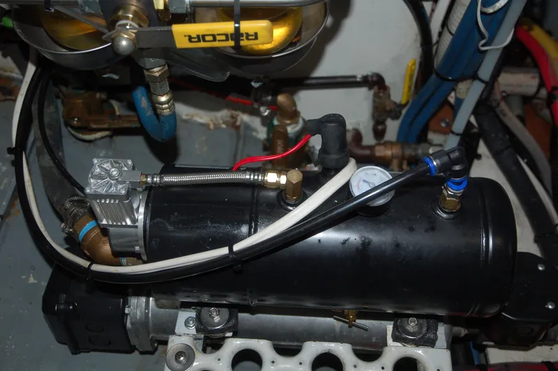 Slide: The Image of Custom 2006 Sprague machinery with pipes, valves, and pressure gauge in a mechanical setup. - 77