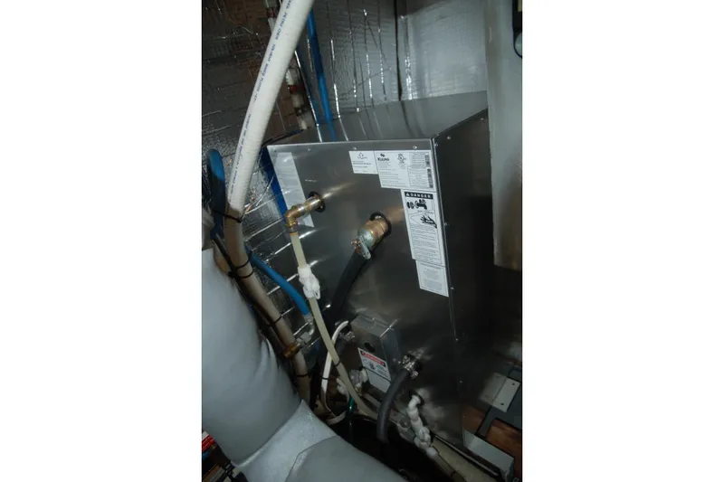 Slide: The Image of Custom Sprague 2006 model equipment with pipes and labels in an industrial setting. - 83