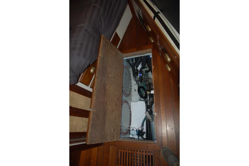 Slide: The Image of Wooden floor hatch revealing mechanical components in a 2006 Custom Sprague boat. - 85
