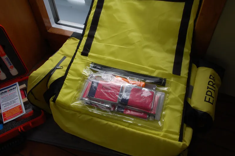 Slide: The Image of Yellow emergency kit with EPIRB, flares, and survival blanket, Custom Sprague 2006 model. - 95