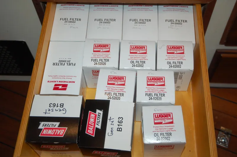 Slide: The Image of Drawer with various fuel and oil filters, including Lugger and Baldwin brands, organized neatly. - 99