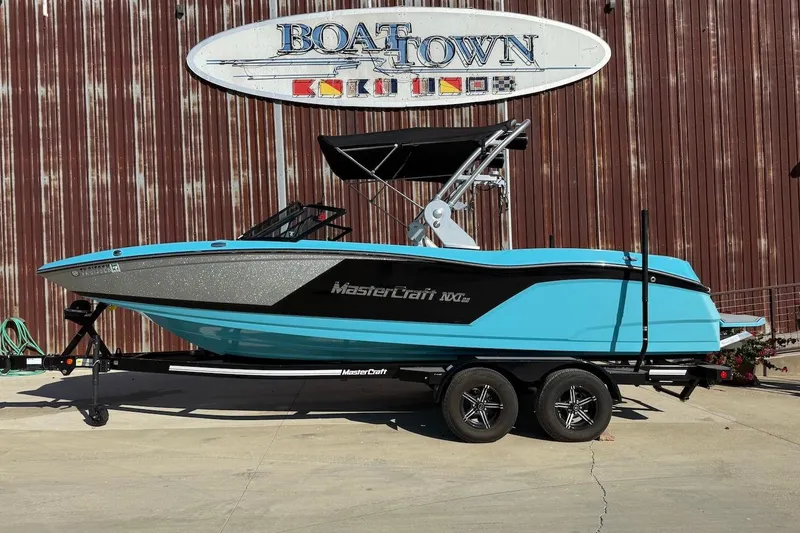 The Image of 2018 MasterCraft NXT22 boat on trailer, parked outside Boat Town building. - 0